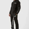 boohooMAN Oversized Graffiti Paint Splatter Gusset Tracksuit | Tracksuits