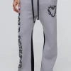 boohooMAN Relaxed Flare Cold Hearted Puff Print Gusset Jogger | Trousers | Joggers