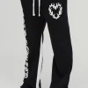 boohooMAN Relaxed Flare Cold Hearted Puff Print Gusset Jogger | Trousers | Joggers