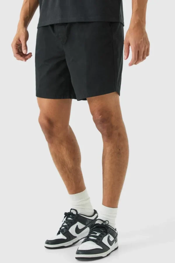 boohooMAN Shorter Length Relaxed Fit Elasticated Waist Chino Shorts in | Trousers | Shorts